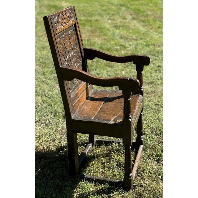 This old oak survivor has a great deal of age charm with a beautifully carved floral motif back panel displaying five...