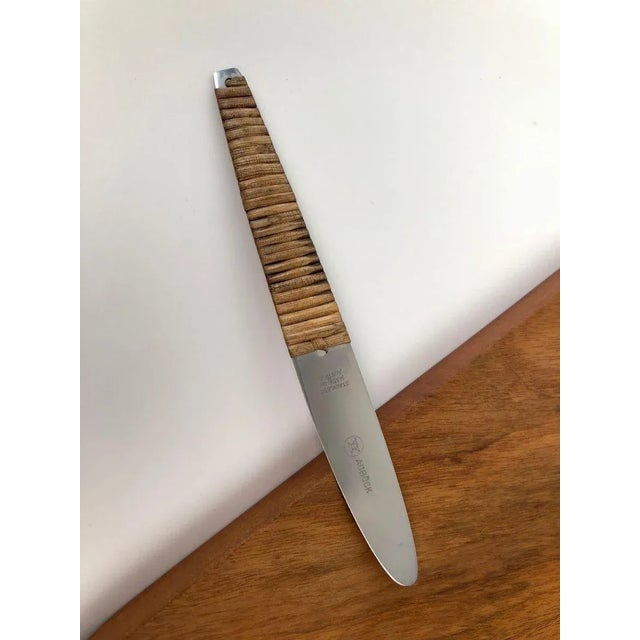 A beautiful vintage triangular cutting board and knife set, designed and made by Carl Auböck in the 1950s. The board is...