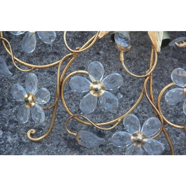 This pair of ceiling lights are a French design in the style of Maison Baguès. They are made of forged and gilded metal...