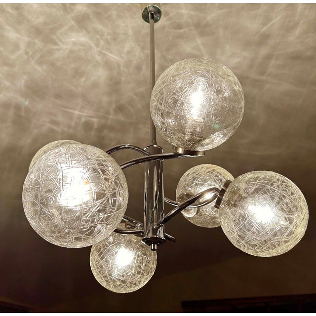 Mid century pendant light, chrome structure with intertwined curved chromed spokes and bubble glass shades height 31.49...