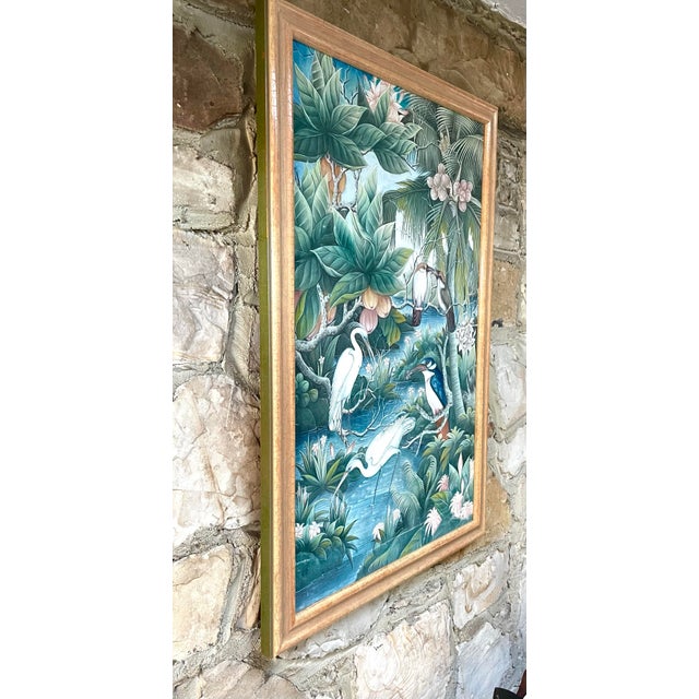 This painting on canvas depicts an idyllic jungle scene with birds amid flowering tropical plants and a flowing stream....