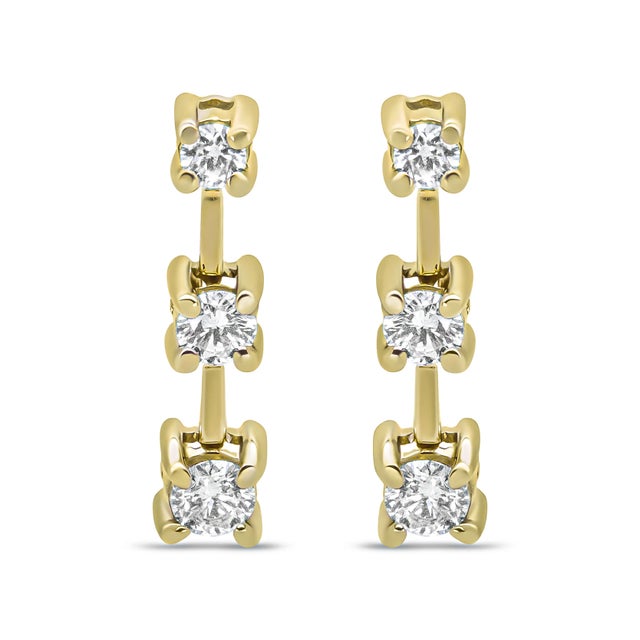 This fabulous three stone diamond earrings are set in a graduating design that align with the smallest stone at the top...