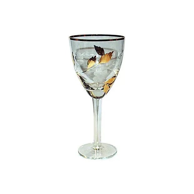 Crystal and 22K gold decorated etched decanter with five matching stemmed glasses. Original country of origin sticker.