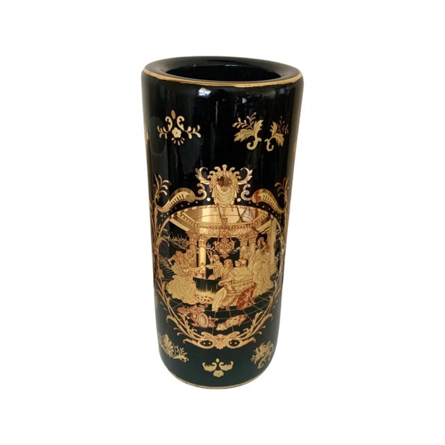 12” tall black glaze ceramic vase with full gilt decoration The scene is out of a tale; the inside of a castle, people...