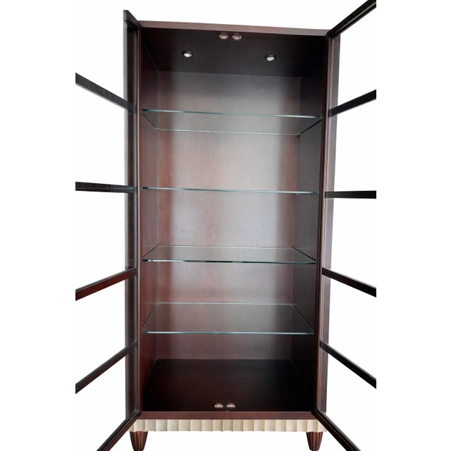 Elegant high-end display cabinet sourced from the Chicago Merchandise Mart, featuring a rich cherry wood finish and...