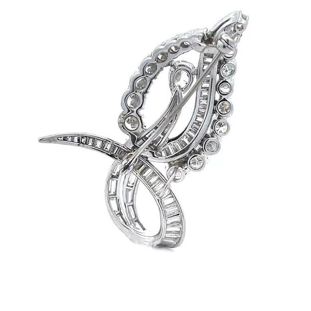 This stunning leaf shape brooch is crafted from platinum, it features a large pear shape upright leaf with a long-curled...