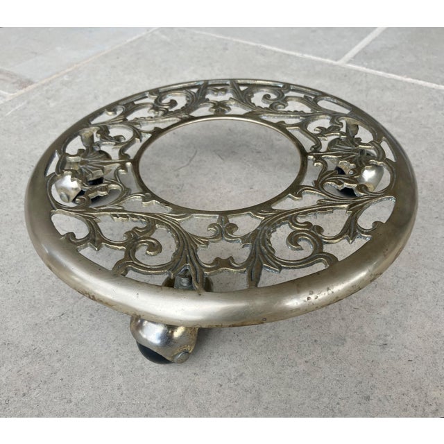 Excellent Pre-Owned Condition. This lovely to look at cast brass leaf and vine filigree motif rolling plant caddy was all...