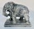 Carved soapstone elephant standing 5" tall with a 3" x 6" base. There is a partial sticker on the bottom that only reads...