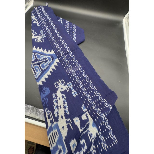 Unique handwoven Sumba warp Ikat textile, a hinggi ( man’s ceremonial mantle ), featuring traditional indigo blue and...