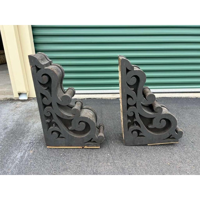 A handsome pair of cast iron decorative brackets crafted circa 2010s in the Victorian / Industrial style, featuring...