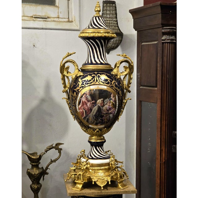 Make a striking statement with this ornate French-style decorative vase, featuring a rich navy blue and white porcelain...