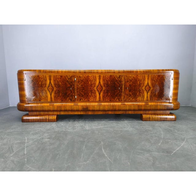 Exceptional Art Deco sideboard produced in Czechoslovakia in the 1930s. Crafted from walnut wood and veneer, this piece...