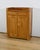 Community furniture in blond cherry, dating from the end of the 19th century. This tall and narrow sideboard has a...