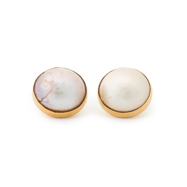 Pair of Mabe Pearl 14K Yellow Gold Earrings, featuring two bezel set round mabe pearls approx. 14.5 - 15.0 mm., worn...