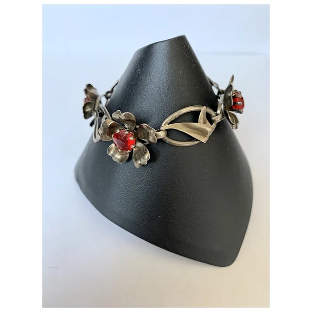 Just in time for summer, a beautiful sterling silver floral link bracelet with red rhinestones in the center of each...