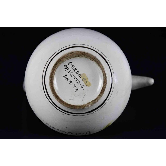 Ceramics pitcher is a original decorative object realized in the 1970s. Made in Italy. The object is realized in colored...