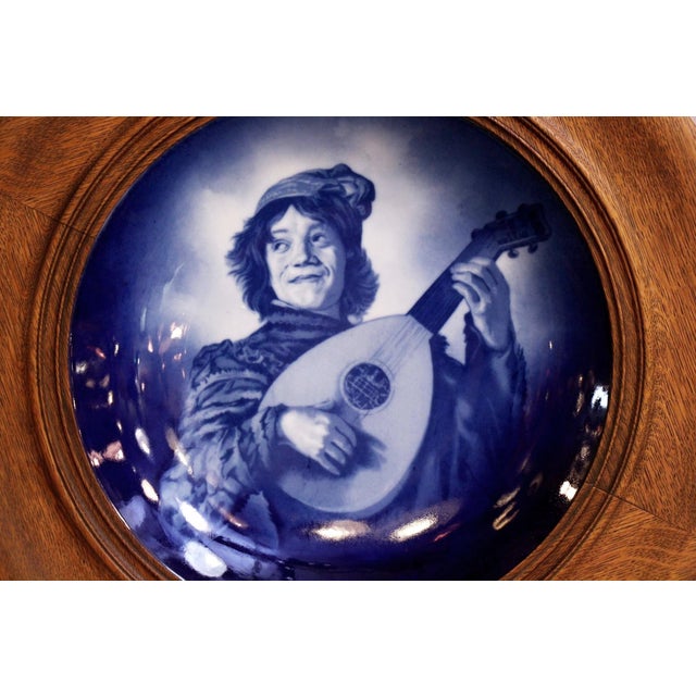 Wood framed plate made after Frans Hals Jester with a guitar. Made in Delf, Germany. The manufacturer and exact date of...