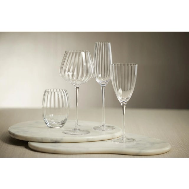 Crafted of beautifully textured glass, the colored glass set features a streamlined design with a pop of color. Raise a...