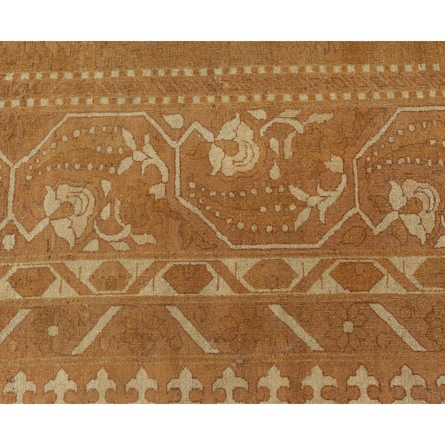 An early 20th century Indian Amritsar antique rug, the tan field with a spacious design of subtle staggered ivory...