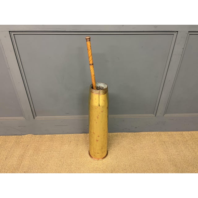 A lovely vintage stick stand made from a brass and copper shell casing. with impressed marks to the underside including...