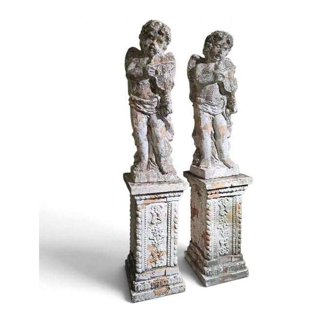 An exceptional and highly decorative pair of 19th-century Italian terracotta sculptures depicting musical cherubs, each...