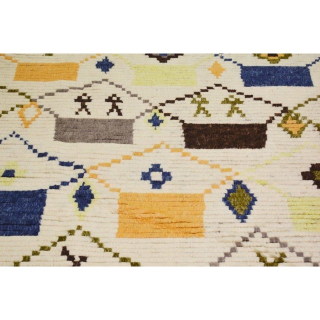 Hand-knotted with care using traditional rug-making techniques, this wool rug blends timeless craftsmanship with a modern...