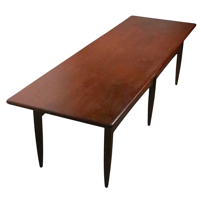 Classic Mid Century, Danish Modern style coffee table constructed of solid wood, probably walnut. The table features six...