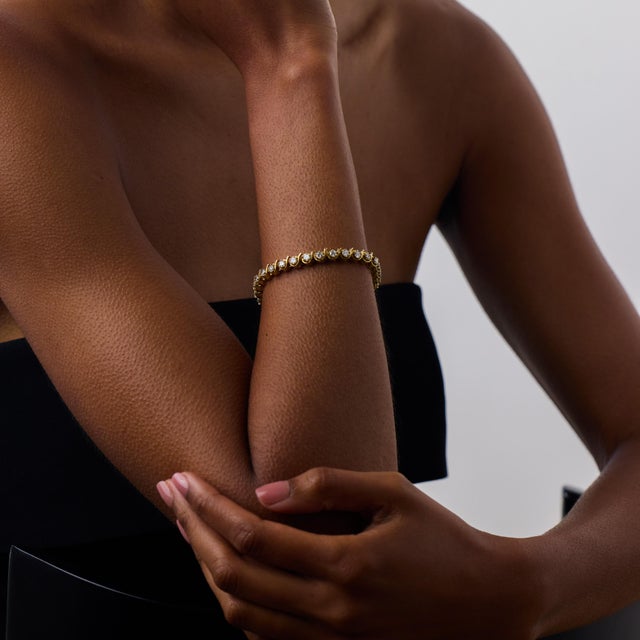 This elegant vintage diamond tennis bracelet is a timeless 1980’s piece, beautifully crafted in 18k yellow gold and set...