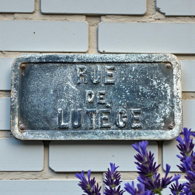 An authentic antique Paris street plaque reading Rue de Lutèce, referencing Lutetia, the Roman name for Paris. This...