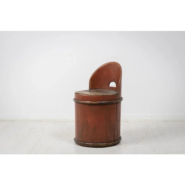 Antique Swedish stump chair in folk art. The chair has a round shape and is made from a hollowed pine tree stump. The...
