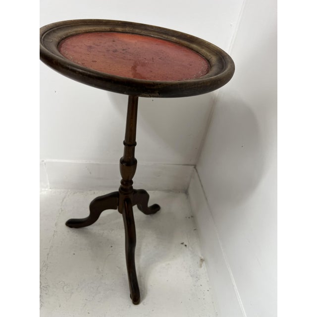 Round Louis XVI style side table in natural wood Tripod base with turned central column Round top with red leather...