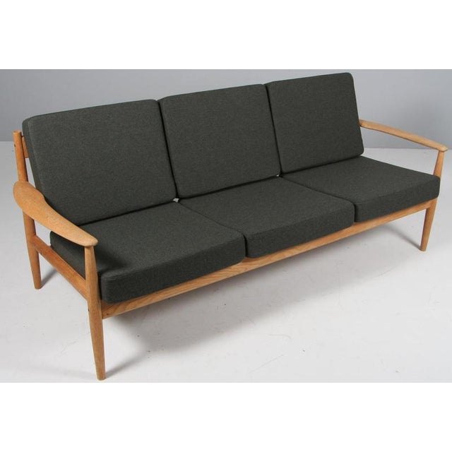 Grete Jalk three seat sofa. with frame of solid oak New upholstery with green Magrethe wool fabric from Nevotex. Made by...