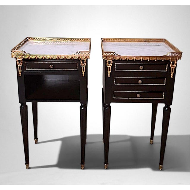 This elegant pair of French nightstands is an outstanding example of the Louis XVI Revival style, crafted in France...