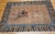 This vintage Chinese Art Deco pictorial area rug captures a striking and dynamic moment: a horseback rider mid-action,...