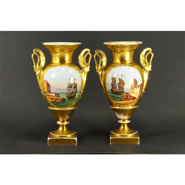 A stunning pair of Empire vases Stylish baluster shape raised on square pedestals Swan shaped handles Fine porcelain...