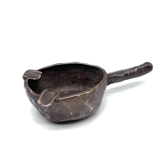 This sculptural ashtray, crafted from solid, dark-patinated bronze, is an outstanding example of German craftsmanship from...