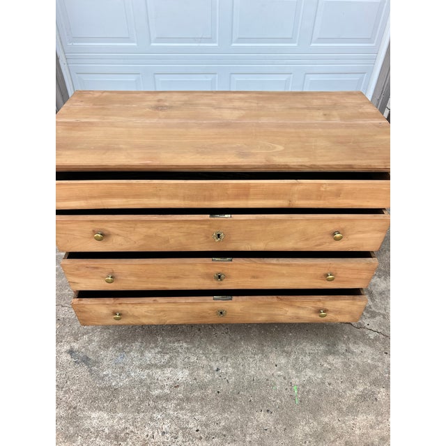 French 19th-century Empire commode crafted in bleached chestnut, featuring three spacious drawers, elegant columnar sides,...