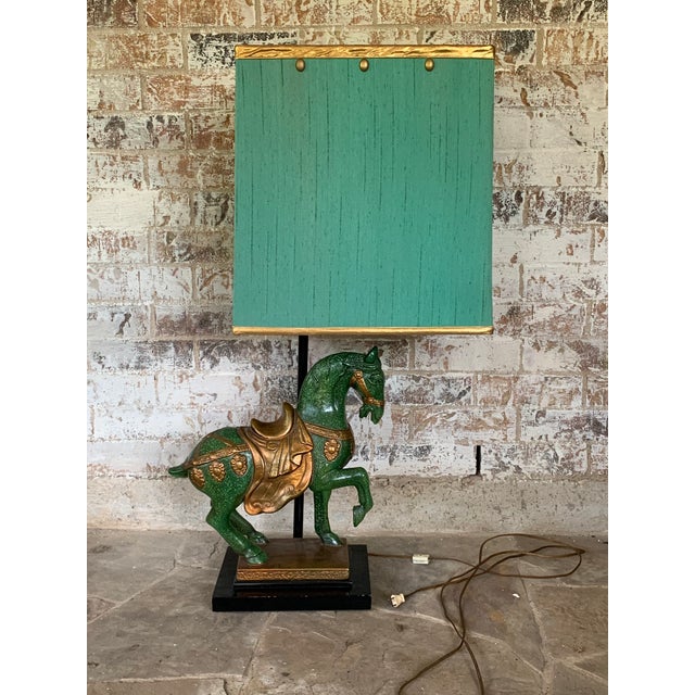 Beautiful Frederick Cooper Horse Tang lamp with original shade. Gorgeous blueish green color with gold accents. Comes with...