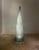 Eric Debras's 1970s floor lamp features a dramatic conical shape reminiscent of a luminous pyramid. The internal metal...