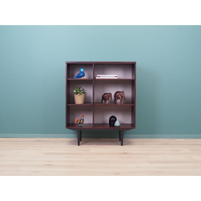 The bookcase was made in the 1960s, produced by the Swedish manufactory Ulferts. The structure is covered with mahogany...