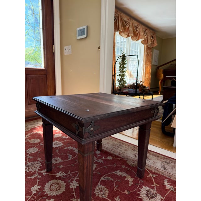 This is a solid rustic wooden end table designed in a Spanish colonial or Indian Thakat style. it features distinctive...