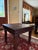 This is a solid rustic wooden end table designed in a Spanish colonial or Indian Thakat style. it features distinctive...