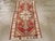 A vintage Turkish Oushak throw rug. A stepped, pendant geometric elongated ivory medallion is set on a red sub-field with...
