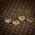 A vintage 20th century set of four gilt solid silver spirit labels. Finely cast and pierced in the form of a naturalistic...