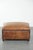 Characterful sheepskin footstool/ottoman with a beautiful patina and finished with black piping. This characterful...