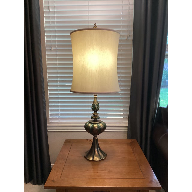 Elevate your interior with this exceptional pair of mid-century table lamps manufactured by the renowned Rembrandt Lamp...
