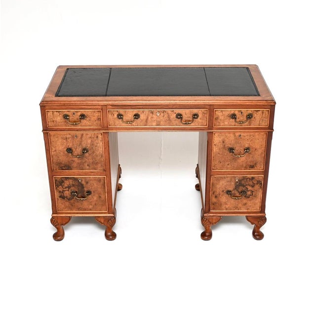A beautiful antique burr walnut leather top pedestal desk. This is in the Georgian style, it dates from around the 1930’s....