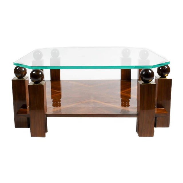 This striking coffee table exemplifies Mid-Century Modern–inspired design through its architectural form and rich material...