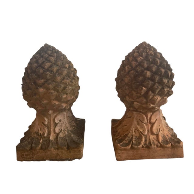 The finials are beautifully sculpted with deep, rhythmic scales on the fruit and elegant, flared acanthus-style leaves at...
