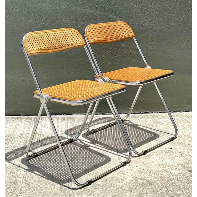 This exceptional pair of vintage Italian folding chairs embodies the understated elegance and functional ingenuity of Mid-...
